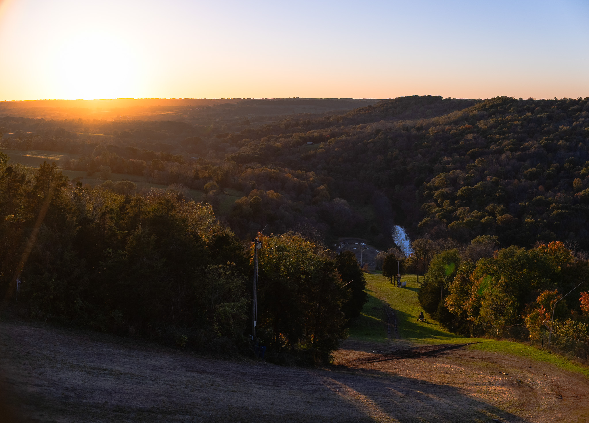 Sunset over the wooded hills and trails at Sundown in the fall